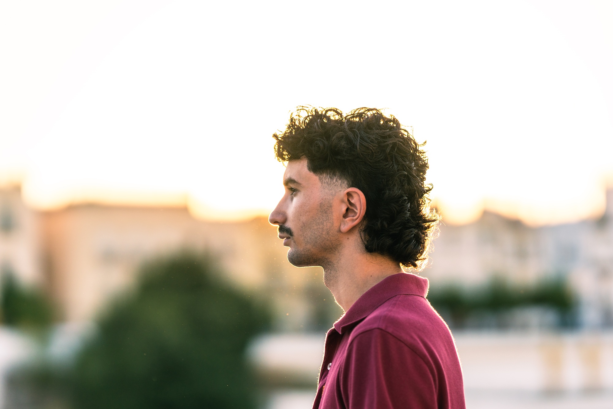 Profile of a young man with modern look in an urban landscape